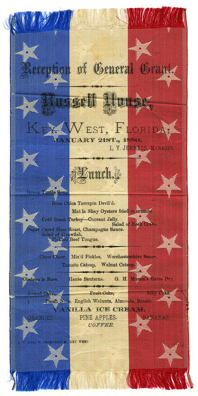 A red, white and blue ribbon with text and a menu printed on it.
