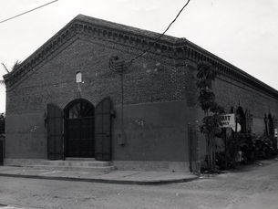 A brick building with an arched doorway in the front