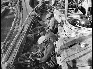People sitting on a boat deck.