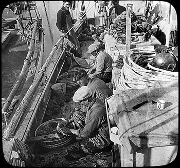 People sitting on a boat deck.