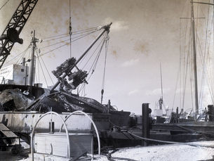 wreckage from a ship next top a dock
