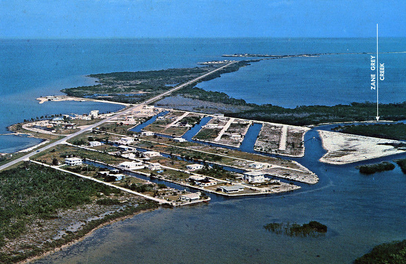 Aerial photo of an island with canals and some homes. Text with an arrow reads Zane Grey Creek.