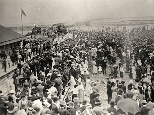 A crowd of people around a train station