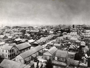 Aerial view of a densely developed town of mostly one and two story buildings