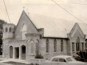 A small church made of bricks with two turrets in the front.
