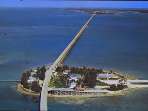 Aerial view of a bridge crossing an island and water.