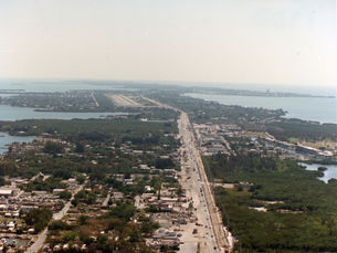 Aerial view of a developed island with a highway going through