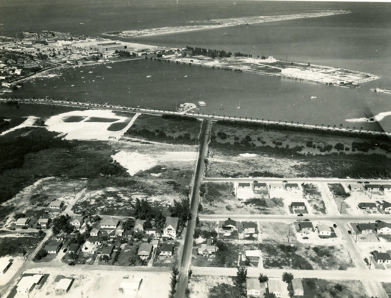 Aerial view of a shoreline with a bridge.