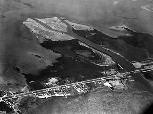 aerial view of an island with a highway and some development