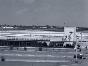 a one story building with a tower at one end and a sign that reads Key West International Airport