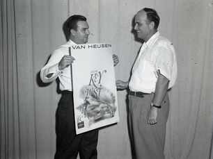 Two men, one holding a poster that reads Van Heusen presents Key West