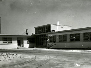 a one story building with two wings