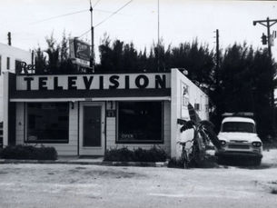 A small store with the word television written across the front