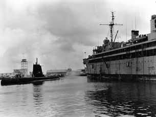 A submarine and a ship in a harbor