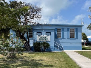 A blue building with a sign that reads Monroe County Public Library
